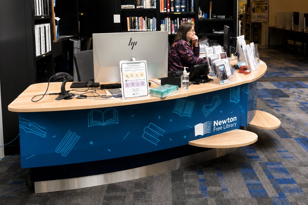 Our YAKETY YAK 305 Counter paired with a YAKETY YAK 306 Counter at Newton Free Library looking smart with custom decals on the panelling.