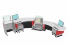Installation comprising: Book Returns Module / YAKETY YAK Radial 305 Counter raised to standing height /Cash Credit Module/ YAKETY YAK 306 Radial Counter lowered to seated height/Under Counter Storage Modules.