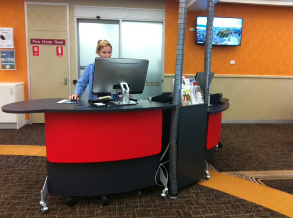 Two YAKETY YAK 202 Desks group around a shared storage pedestal to form a service point at Casuarina Library.