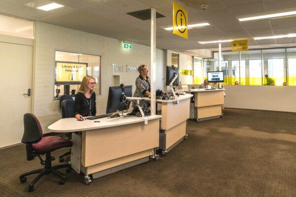 Height adjustable YAKETY YAK 204 Desks in the seated and standing positions at Flinders University.